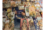 A large spread of illustrated tarot cards filling the frame, showing various fantasy and mystical card designs with moons, figures, and scenic artwork.