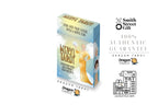 Dragon Tarot deck box shown on a white background with multiple brand logos, social media icons, and promotional text. The box is light blue with a yellow-gold title and an illustration of a woman in a flowing yellow dress.