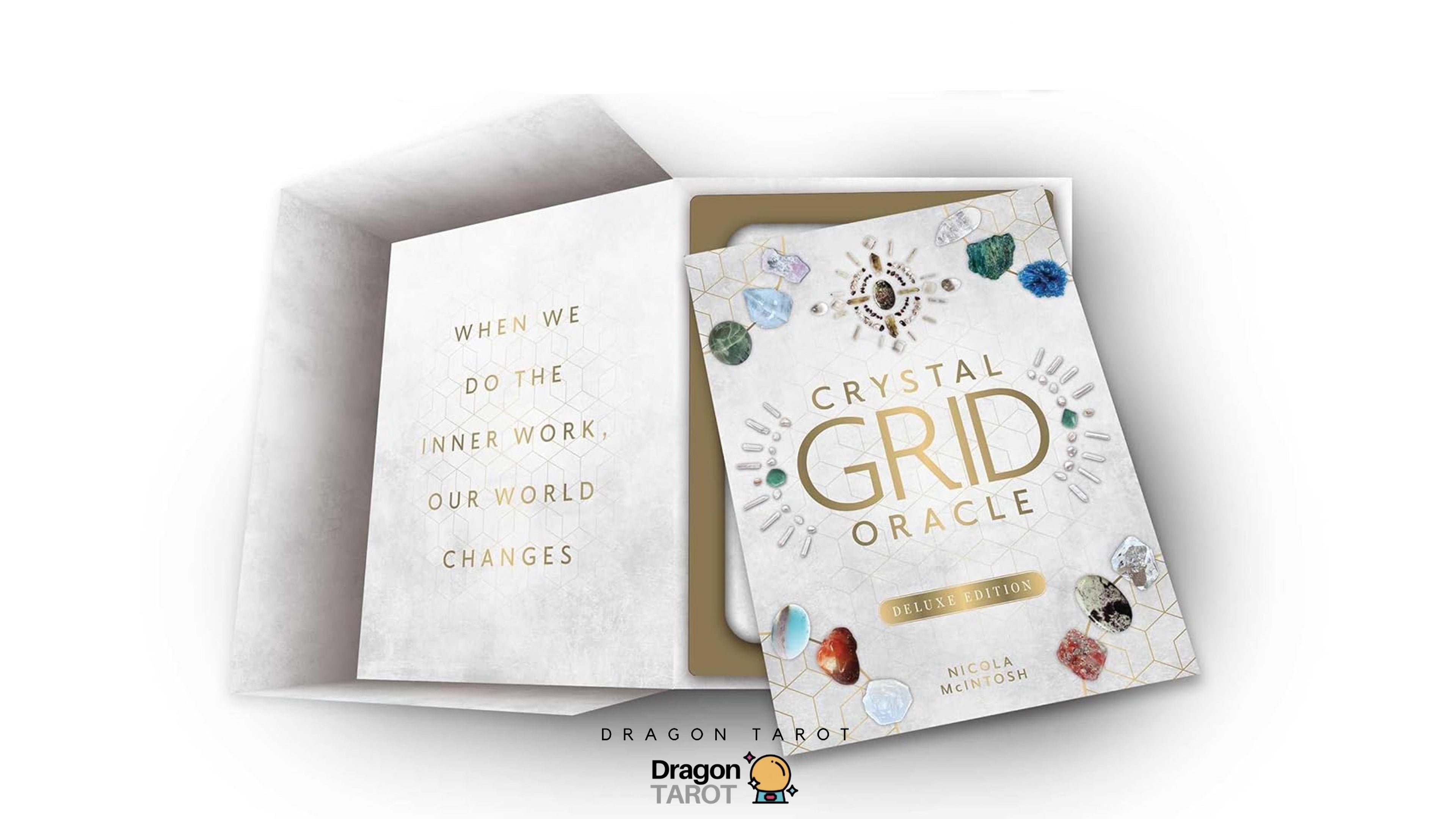 Dragon Tarot Crystal Grid Oracle deck shown in an open white box with a gold interior, featuring a white card cover decorated with colorful crystals and gold lettering.