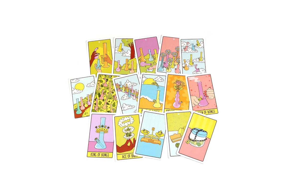 A set of illustrated tarot cards arranged in a loose cluster on a plain white background. The cards feature whimsical, colorful drawings with yellow, pink, blue, and orange tones, and several cards show text such as 'KING OF HOME,' 'MUT TITHE,' and 'THE FLOW.