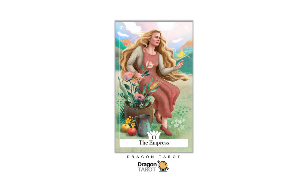 A tarot card titled 'The Empress' shown centered on a white background, with the Dragon Tarot logo below. The card features an illustrated woman with long blonde hair seated beside a pot of flowers and fruit in a soft pastel landscape.