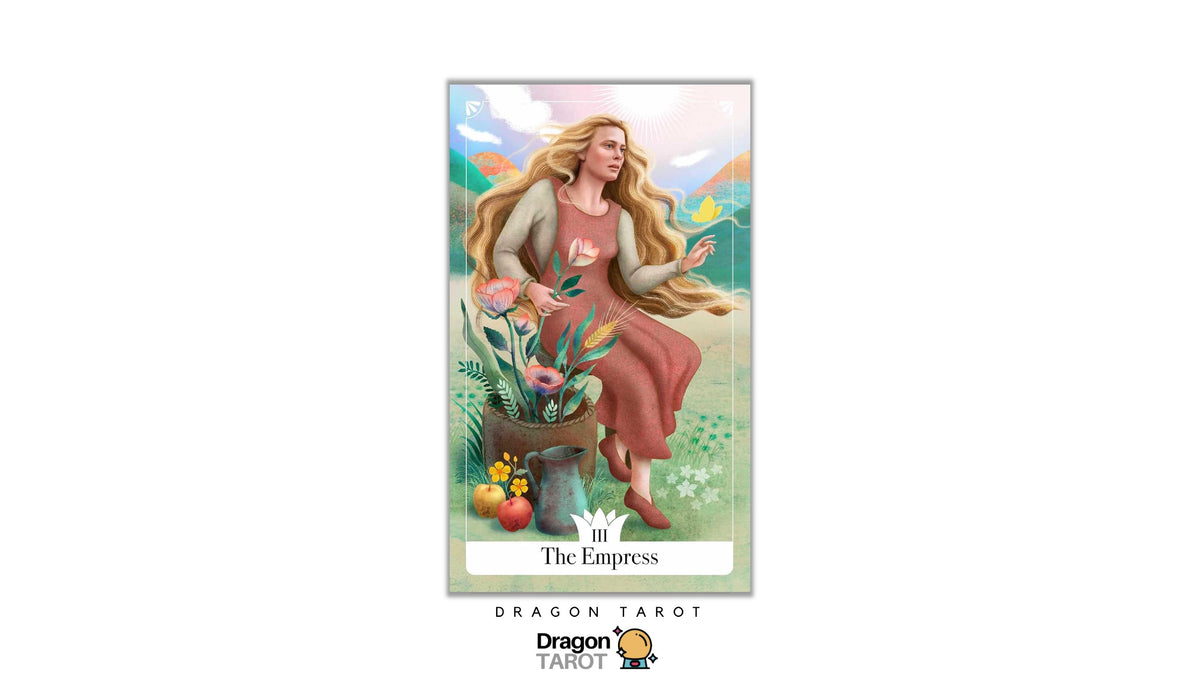 A tarot card titled 'The Empress' shown centered on a white background, with the Dragon Tarot logo below. The card features an illustrated woman with long blonde hair seated beside a pot of flowers and fruit in a soft pastel landscape.