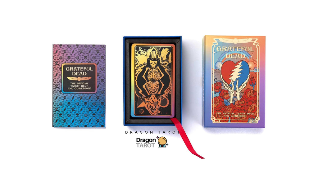 Three Dragon Tarot deck components displayed on a white background: a blue-to-purple gradient deck box, an open black box showing a tarot card with a skeleton and gold details, and the front of the deck box with Grateful Dead artwork and a red ribbon. Thai text and Dragon Tarot branding are visible.