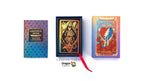 Three Dragon Tarot deck components displayed on a white background: a blue-to-purple gradient deck box, an open black box showing a tarot card with a skeleton and gold details, and the front of the deck box with Grateful Dead artwork and a red ribbon. Thai text and Dragon Tarot branding are visible.