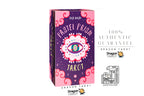 A boxed tarot card deck titled 'Pastel Prism Tarot' by Jad Mado, shown upright on a white background with promotional text and logos for Dragon Tarot. The box is predominantly pink and purple with a central eye illustration and decorative swirls.