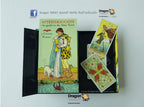 A tarot card deck set displayed on a light gray background, featuring a black binder with an illustrated card cover titled 'Afterthoughts' and two loose tarot cards showing floral and animal illustrations. Dragon Tarot branding is visible.