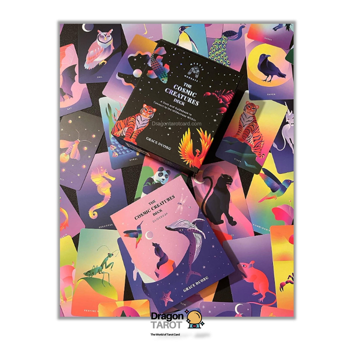 A colorful illustrated tarot card deck box and cards displayed on a white background. The packaging features vibrant fantasy-style artwork with cats, crows, and mystical figures in shades of purple, pink, orange, yellow, and green.