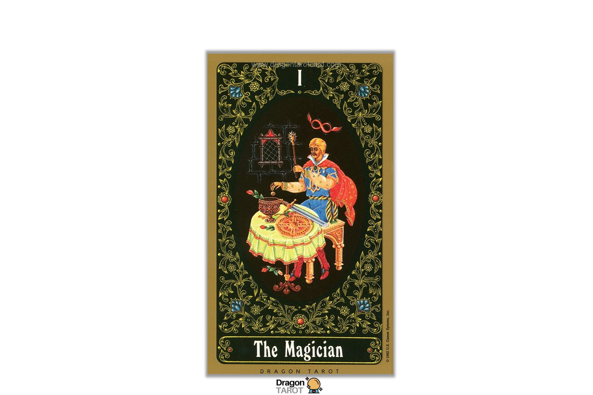 A tarot card titled 'The Magician' shown vertically against a white background. The card features an ornate gold border, a dark green floral frame, and a central black oval containing an illustration of a figure in a blue robe with a red cape, seated at a table with a cauldron.