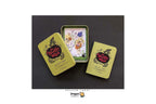 Dragon Tarot card deck shown with two olive-green metal tin boxes and one open tin displaying illustrated cards on a dark background. The image includes Dragon Tarot branding and a Facebook header.