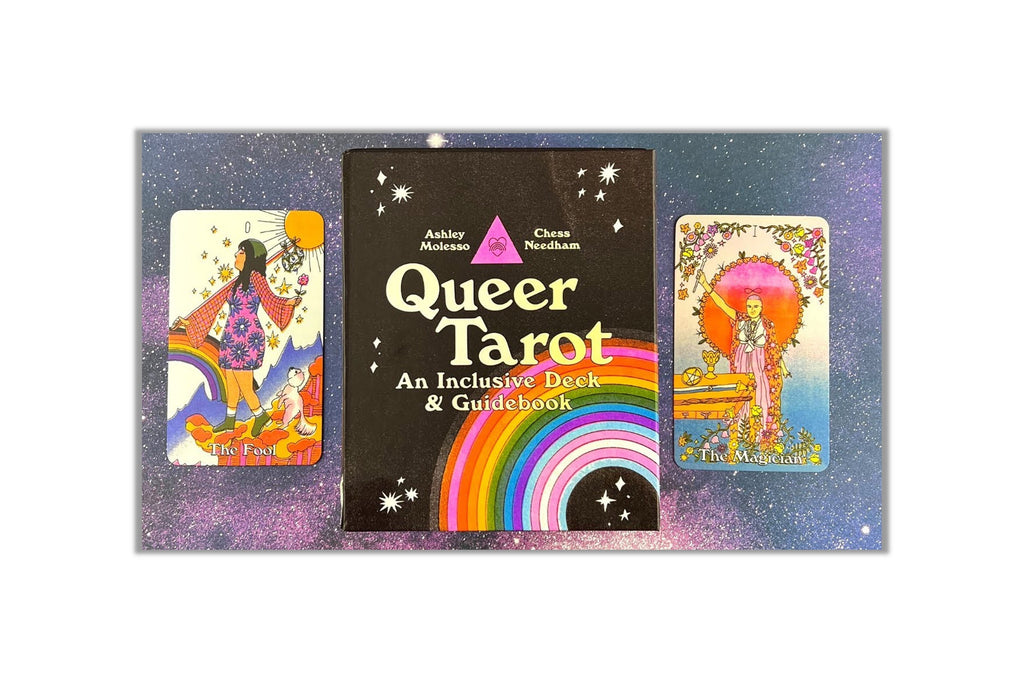 Queer Tarot deck and guidebook set featuring a central black box with a rainbow and the title 'Queer Tarot' flanked by two illustrated tarot cards on a purple glittery background.