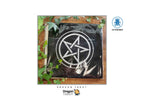 A black Dragon Tarot deck in plastic wrapping with a white pentagram symbol on the front, displayed on a wooden surface with green ivy leaves. The image has 'Dragon Tarot' branding and a 'LO SCARABIO' logo on a white background.