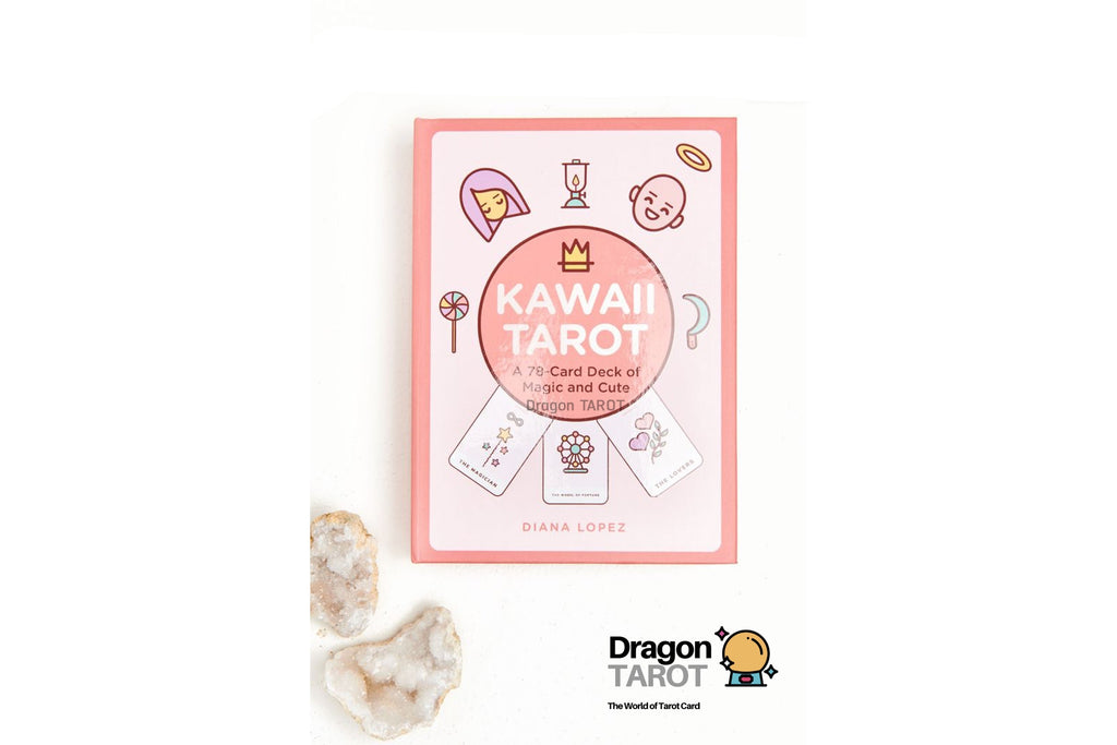Kawaii Tarot deck box shown on a white background with two small crystal stones at the lower left. The box is light pink with cute cartoon illustrations and the title 'KAWAII TAROT' in white.