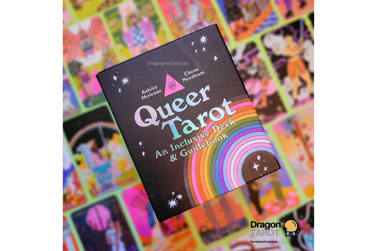 A black tarot card book titled "Queer Tarot" with a rainbow graphic on the cover, held in front of a colorful collage of tarot cards. The Dragon's Trail logo is visible in the bottom right corner.