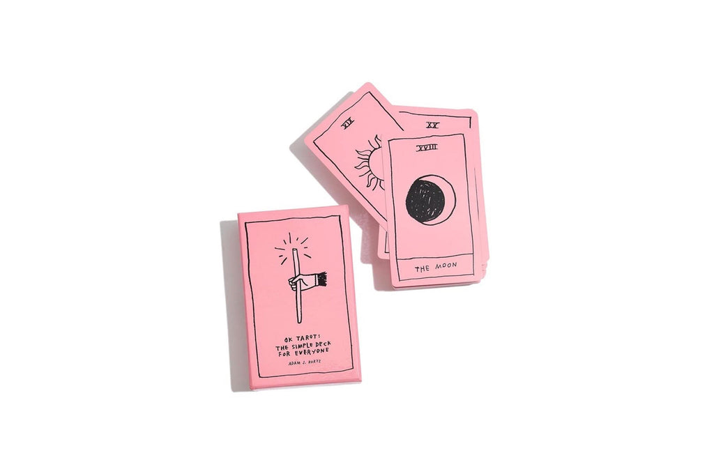 Three pink tarot cards with black line art and text, including 'The Hanged Man' and 'The Moon', arranged on a plain white background.