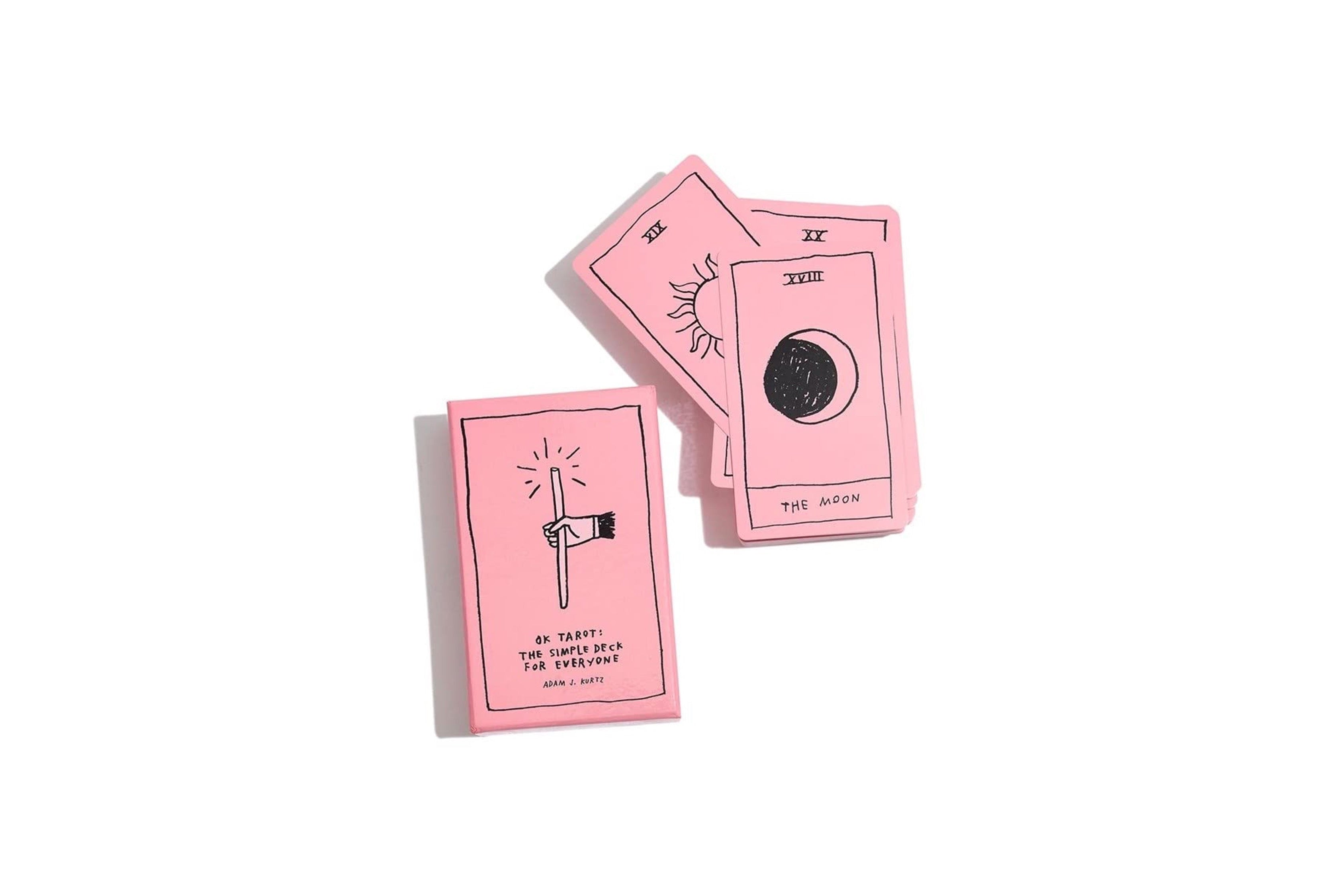 Three pink tarot cards with black line art and text, including 'The Hanged Man' and 'The Moon', arranged on a plain white background.