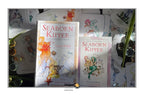 Two illustrated art decks for 'Seaborn Kipper' and 'Transcending the Kipper' by Thomas Wickhelth, displayed with cards and small glass vessels on a dark surface.