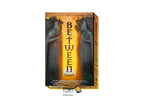 In Between Tarot deck box shown at a slight angle on a plain white background, with illustrated stone figures and a glowing vertical title panel. A Dragon Tarot watermark appears near the bottom.