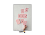 A flat-lay view of a Dragon Tarot deck on a light gray textured surface, showing several pink cards and a pink box, with a hand reaching in to pick up one card. The brand logo 'Dragon Tarot' is visible at the bottom of the image.