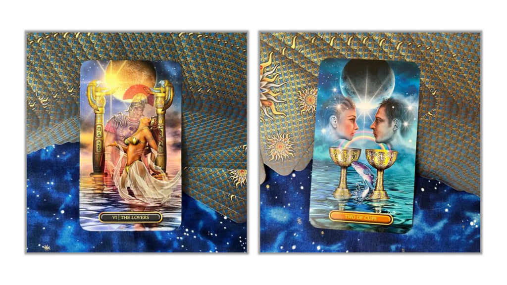 Two tarot cards displayed side by side against a decorative blue and gold patterned background. The left card shows a seated figure with a glowing sun and the title 'VICTOR VANCE'; the right card shows two faces above two gold chalices in water with a blue cosmic background.