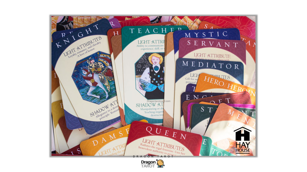 A set of tarot card decks and individual cards from the Hay House Dragon Tarot deck, featuring colorful illustrated card backs with text such as Knight, Servant, Mediator, Queen, and Hero. The cards are arranged overlapping each other on a light background.