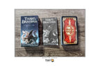 Three Dragon Tarot cards shown on a rustic wood background: the 'Tarot de Dracosis' deck box on the left, the 'Tarot de Dracosis' deck in the middle, and the red-backed card deck on the right. The Dragon Tarot logo is visible at the top and bottom of the image.