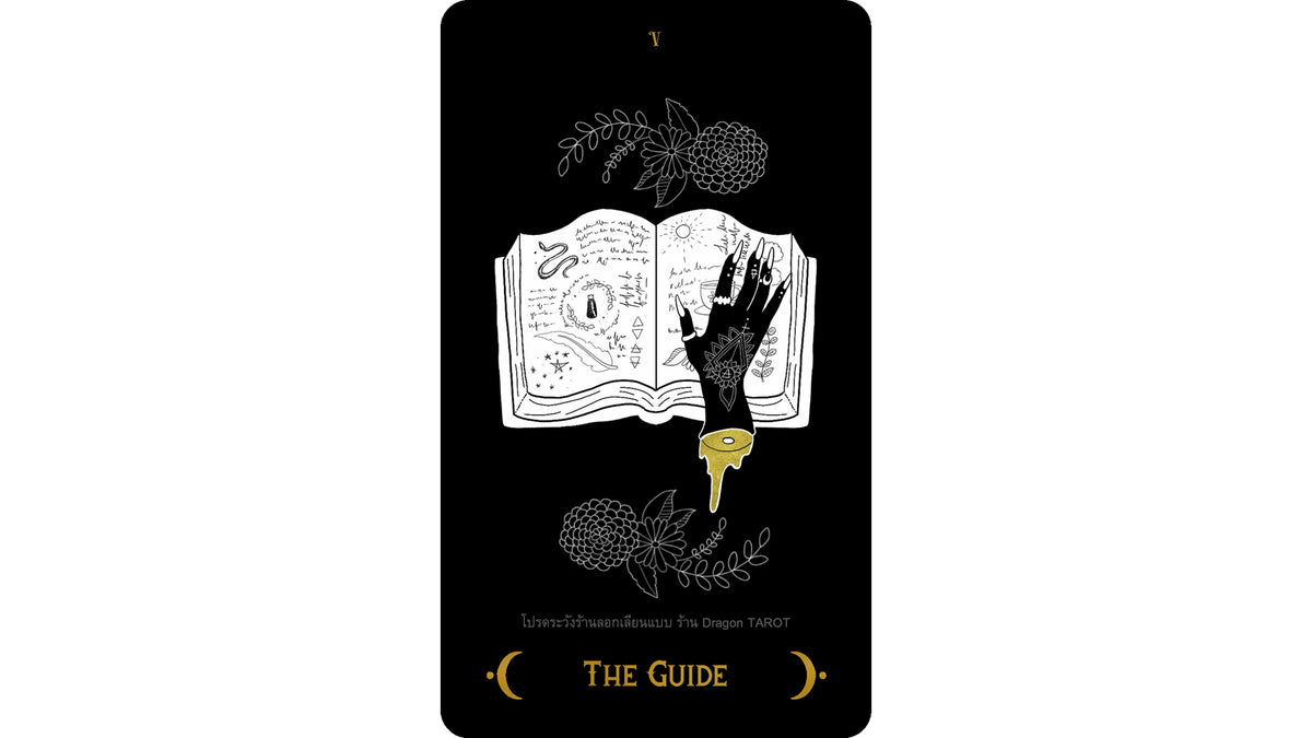 A tarot card titled 'THE GUIDE' from 'Lines of Fate' by The Dragon Tarot, featuring a black background with white line art of an open book, a hand, and botanical illustrations, accented with gold text and a gold key.