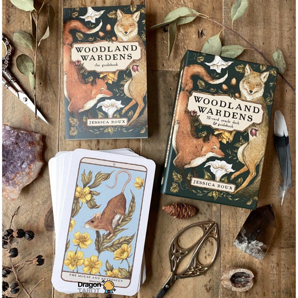 Two illustrated book covers for 'Woodland Wardens' by Jessica Wood are displayed on a rustic wooden surface with tarot cards, a knife, crystals, and dried leaves. The covers feature woodland animals like foxes, mice, and birds in earthy green, brown, and beige tones.