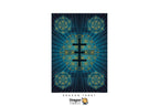 A Dragon Tarot card featuring a central black cross over a blue and black geometric design with gold lines, shown on a white background with brand logos at the top and bottom.