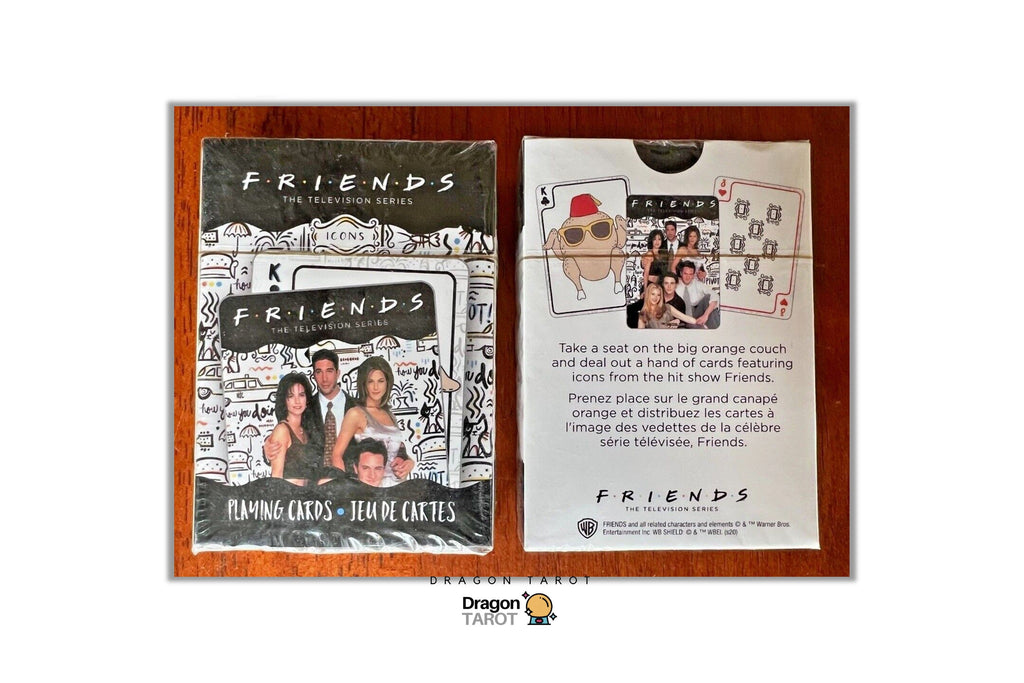 Two Dragon Tarot 'Friends' themed oracle cards displayed side-by-side on a wooden surface. The left card, titled 'FRIENDS THE RELEASING SERIES', features a black and white sketch-style illustration of the main characters.