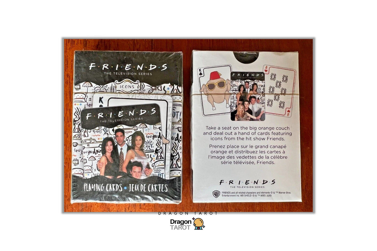 Two Dragon Tarot 'Friends' themed oracle cards displayed side-by-side on a wooden surface. The left card, titled 'FRIENDS THE RELEASING SERIES', features a black and white sketch-style illustration of the main characters.