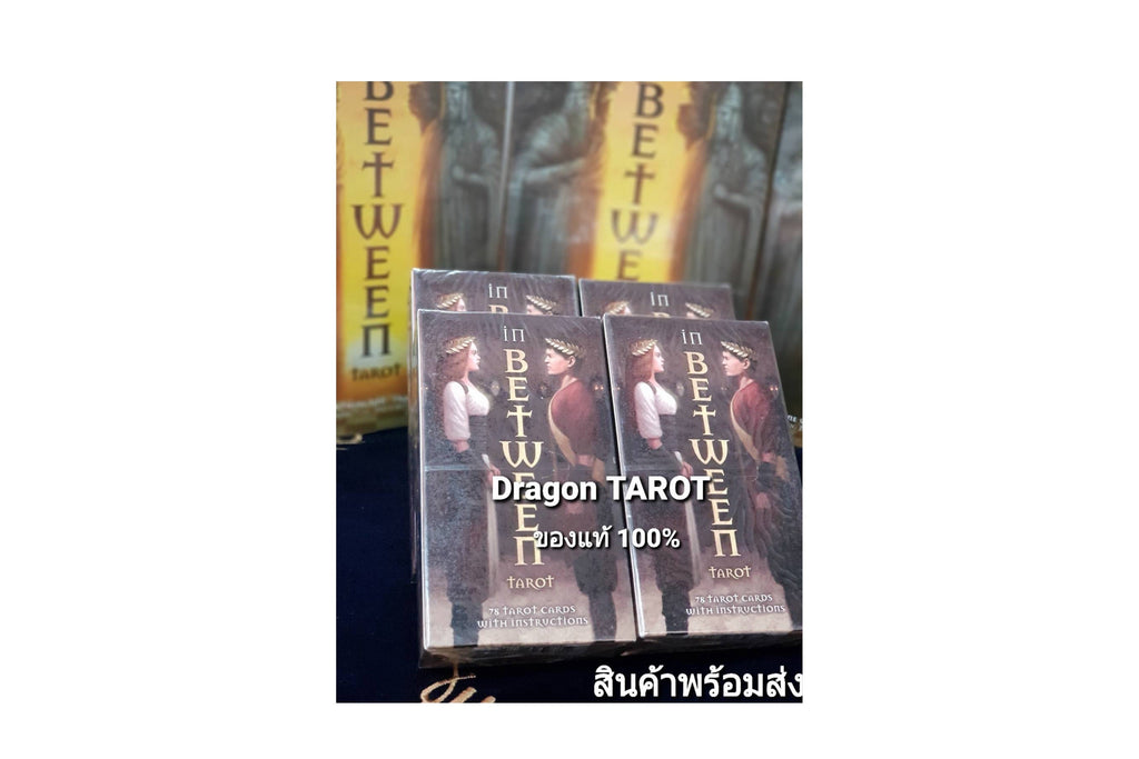 Four boxed tarot card decks titled 'in BETWEEN' stacked on a dark surface, with a larger matching box behind them. The boxes show illustrated figures and the text 'Dragon TAROT' and '100%'.