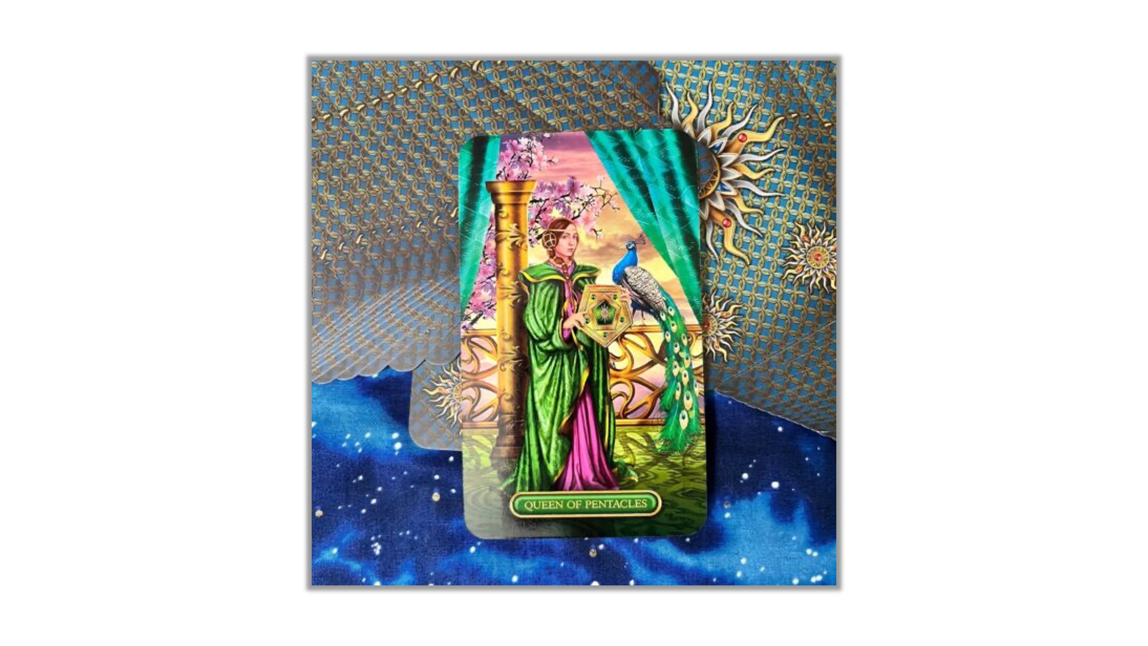 A tarot card deck box or card package featuring a colorful illustrated card with a woman in green and pink robes beside a golden pillar and blue bird, set against a decorative blue and gold patterned background.