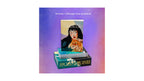 A boxed card deck and guidebook set displayed on a purple gradient background. The set includes a deck of 'Dark Romance Sazes' cards in a green box with gold lettering, a matching guidebook featuring an illustration of a woman and cat, and a stack of cards.