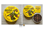 A product presentation of a Dragon Tarot 'Original 1909' circular edition tarot deck, showing the yellow circular box, the yellow booklet, and an open view of the black patterned card deck on a light wood background.