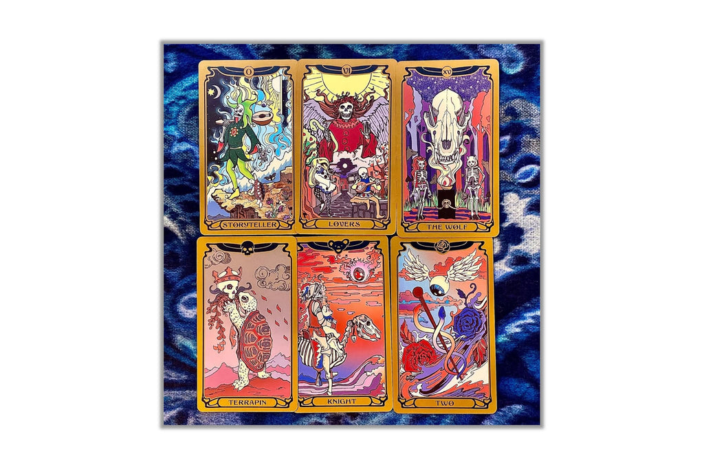 Six illustrated tarot-style cards arranged in a 2x3 grid on a blue marbled background. The cards feature colorful fantasy and skeletal artwork with gold borders, and the overall composition is centered on a white page-like background.