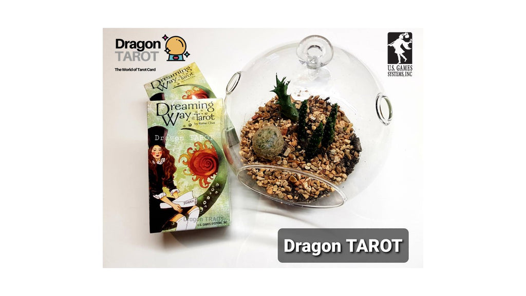 Dragon Tarot deck packaging and a glass terrarium display on a white background, with Dragon Tarot branding and a US Game Developers Choice 2023 logo visible.